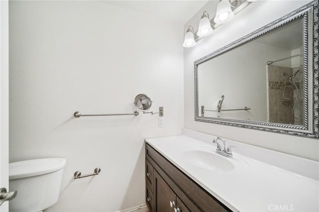 bathroom featuring a shower, vanity, and toilet