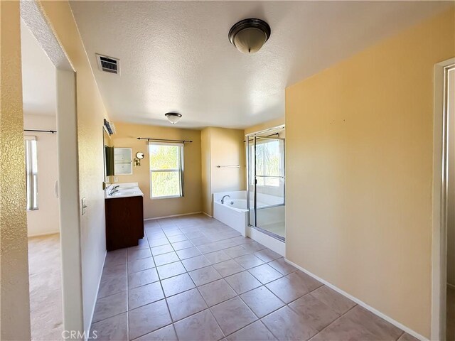 bathroom featuring vanity, tile patterned flooring, independent shower and bath, and a textured ceiling