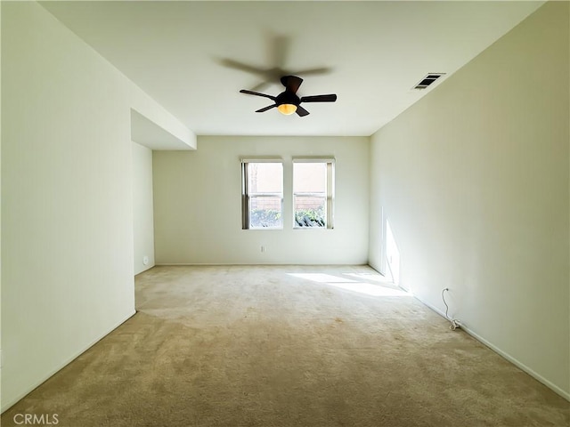 empty room featuring light carpet and ceiling fan