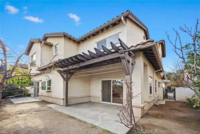 rear view of house with a pergola and a patio area