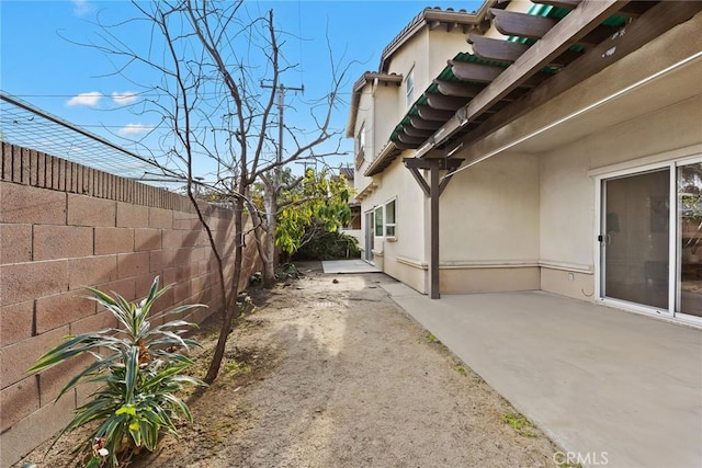 view of side of property featuring a patio