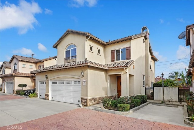 mediterranean / spanish-style home with a garage