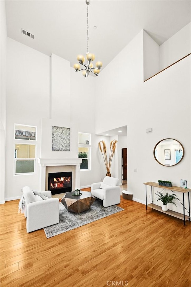 living room featuring wood-type flooring and a notable chandelier