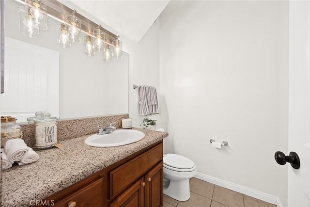 bathroom with vanity, tile patterned floors, and toilet