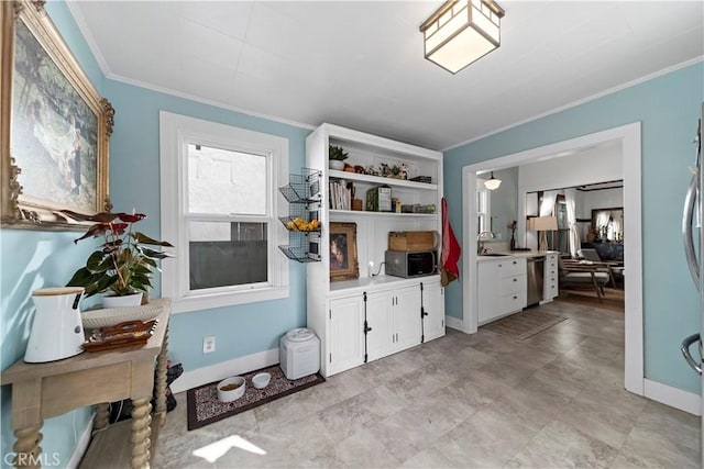 interior space featuring dishwasher, white cabinetry, sink, and crown molding