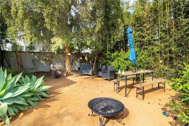 view of patio / terrace featuring an outdoor fire pit