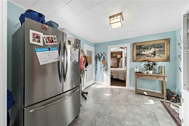 kitchen featuring white cabinetry and stainless steel refrigerator