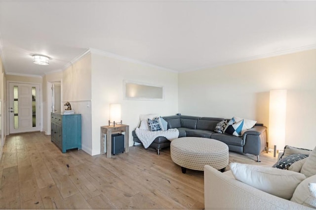 living room with light hardwood / wood-style flooring and ornamental molding