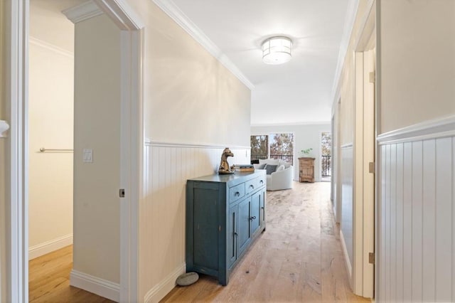 corridor featuring crown molding and light hardwood / wood-style flooring