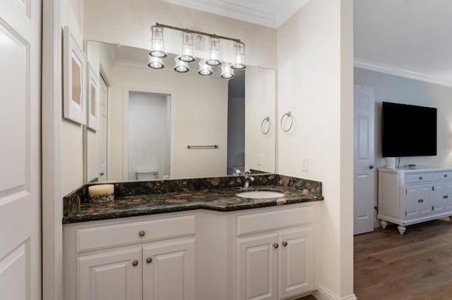 bathroom featuring ornamental molding, hardwood / wood-style floors, vanity, and toilet