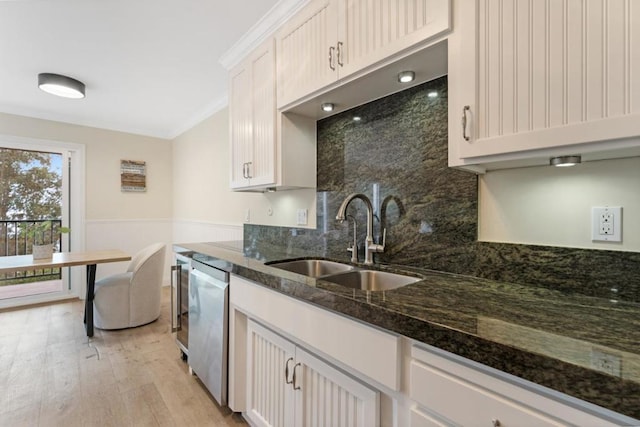 kitchen with white cabinetry, sink, light hardwood / wood-style flooring, and dishwasher