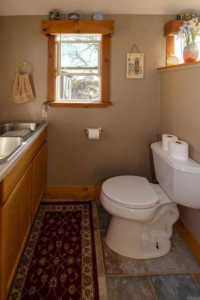 bathroom with vanity, tile patterned floors, and toilet