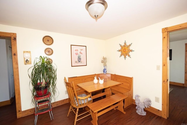 dining space with dark hardwood / wood-style floors