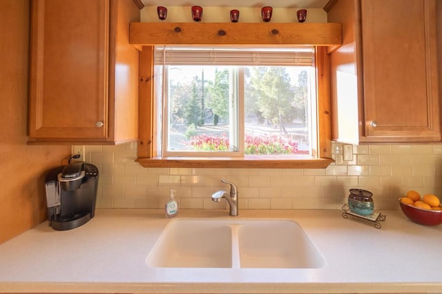 kitchen featuring tasteful backsplash and sink