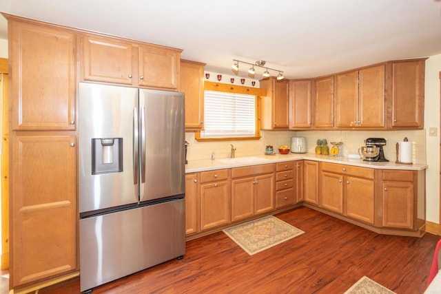 kitchen with sink, dark wood-type flooring, and stainless steel fridge