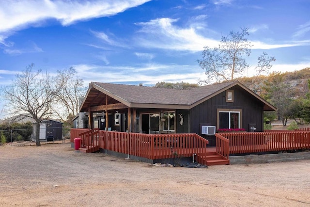 rear view of house with a wooden deck