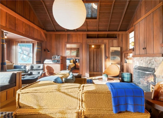 living room with vaulted ceiling with beams, wood ceiling, wooden walls, and a high end fireplace