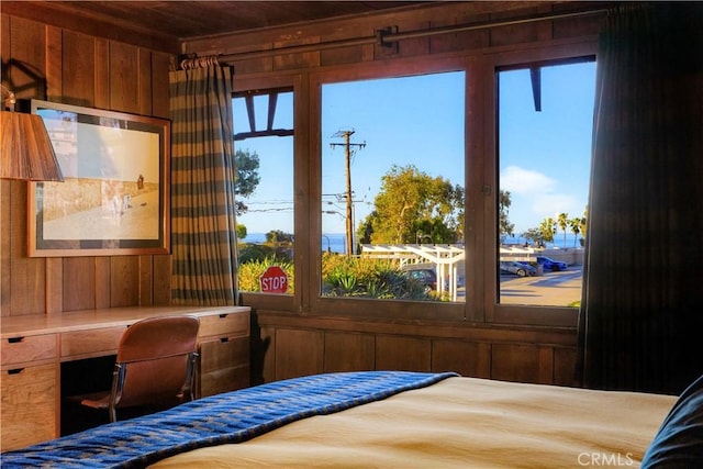 bedroom featuring wooden walls