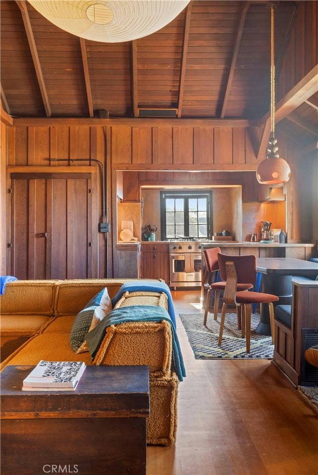 bedroom featuring wood ceiling, vaulted ceiling with beams, hardwood / wood-style flooring, and wooden walls