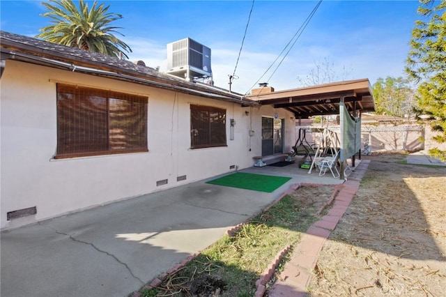 rear view of house featuring central AC and a patio area