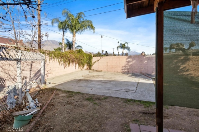 view of yard featuring a mountain view and a patio area