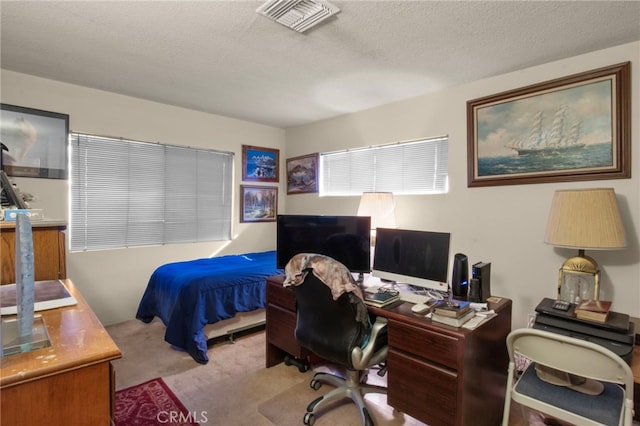 carpeted bedroom featuring a textured ceiling