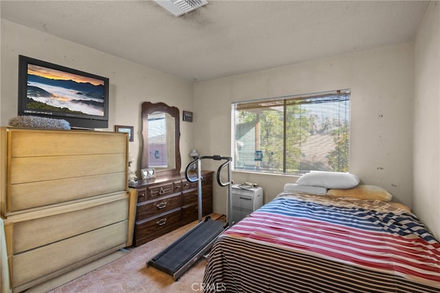 carpeted bedroom featuring a textured ceiling