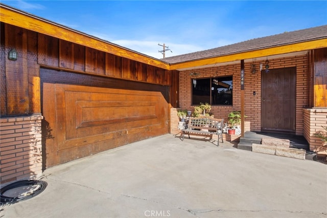 view of exterior entry featuring a patio area