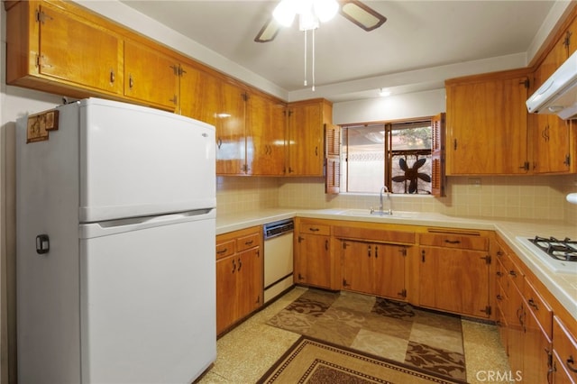 kitchen featuring sink, white appliances, backsplash, ceiling fan, and exhaust hood