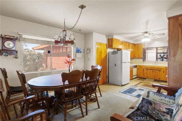 dining room featuring ceiling fan and sink