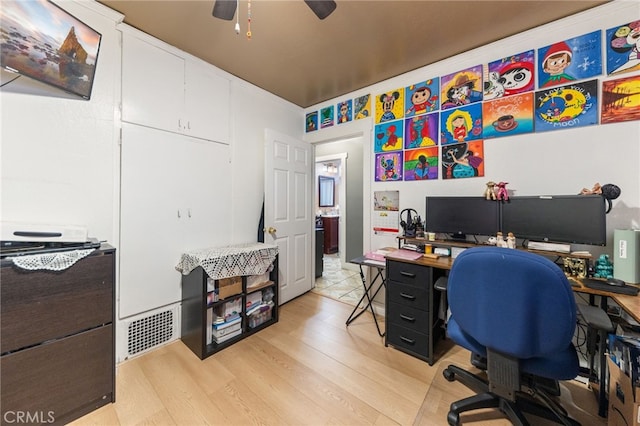 home office featuring ceiling fan and light hardwood / wood-style floors