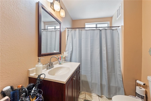 bathroom with vanity, toilet, and a shower with shower curtain