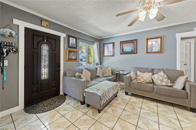 living room featuring ornamental molding, light tile patterned flooring, ceiling fan, and a textured ceiling