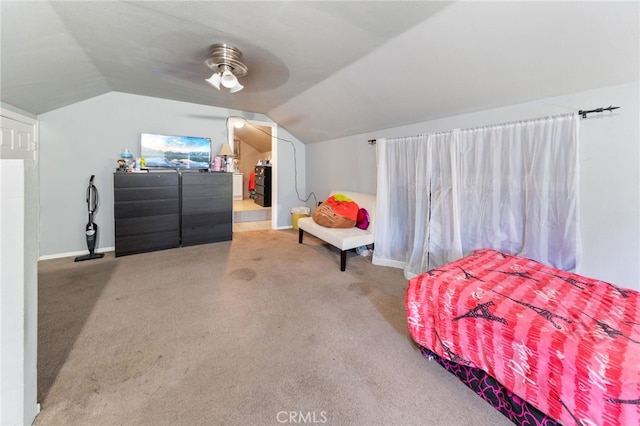 carpeted bedroom with vaulted ceiling and ceiling fan