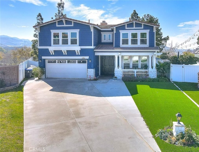 5761 John Bixby Ln, Yorba Linda, CA 92887 - craftsman-style home with an attached garage, driveway, covered porch, stone siding, and a chimney