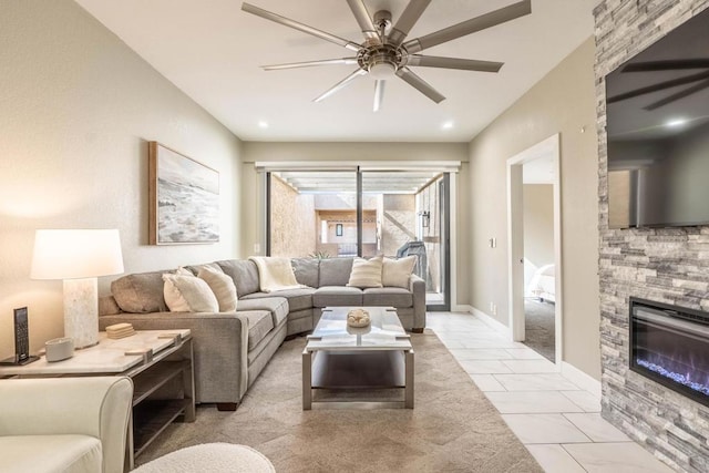 living room featuring ceiling fan and a fireplace