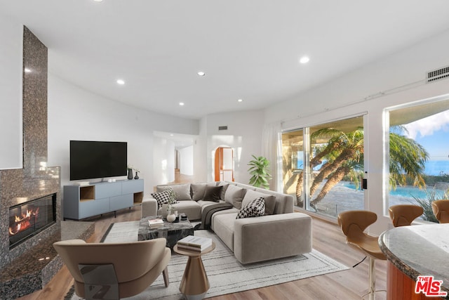 living room featuring a fireplace and light hardwood / wood-style flooring