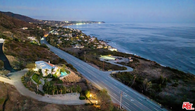 aerial view at dusk with a water view