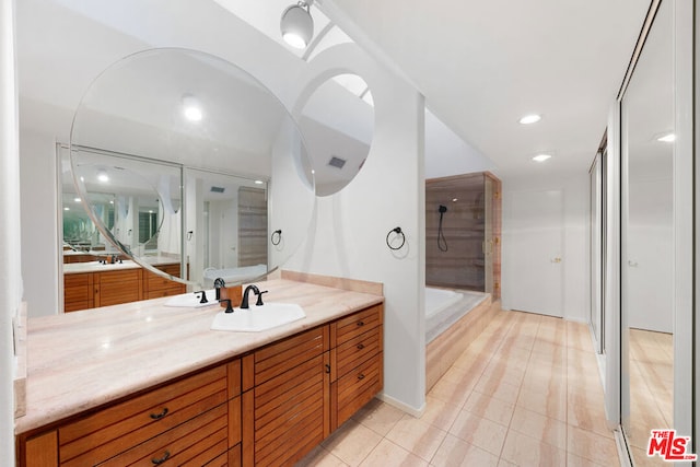 bathroom featuring vanity, a shower with shower door, and tile patterned floors