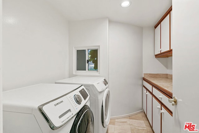 washroom with separate washer and dryer and cabinets