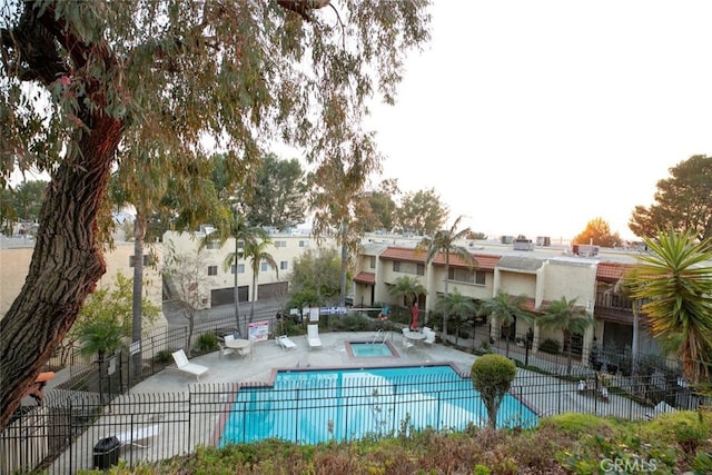 view of pool featuring a community hot tub and a patio area