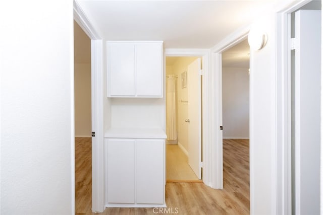 corridor featuring light hardwood / wood-style floors