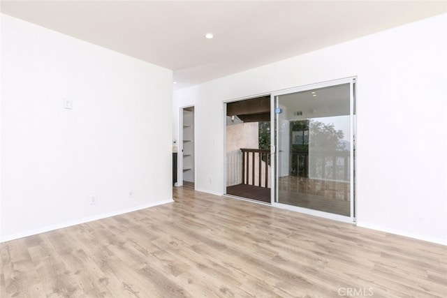 spare room featuring light wood-type flooring