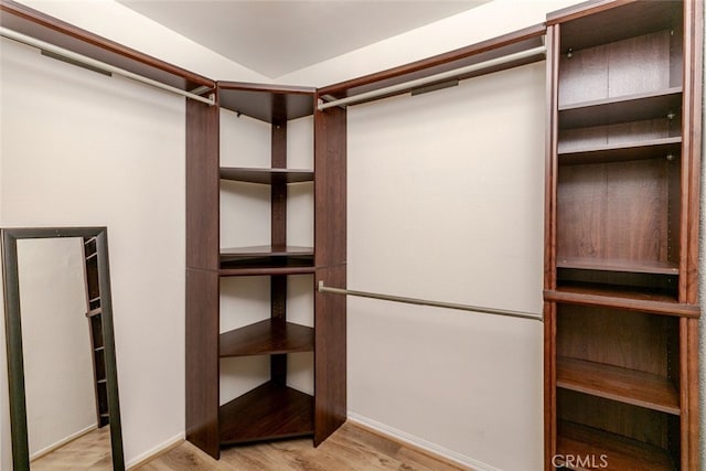 walk in closet with light wood-type flooring