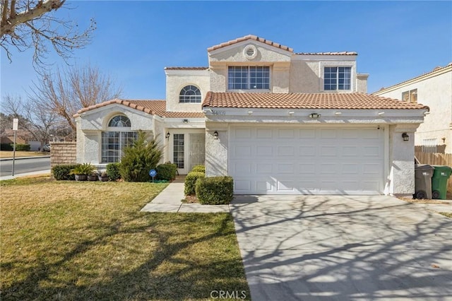 mediterranean / spanish-style home featuring a garage and a front lawn