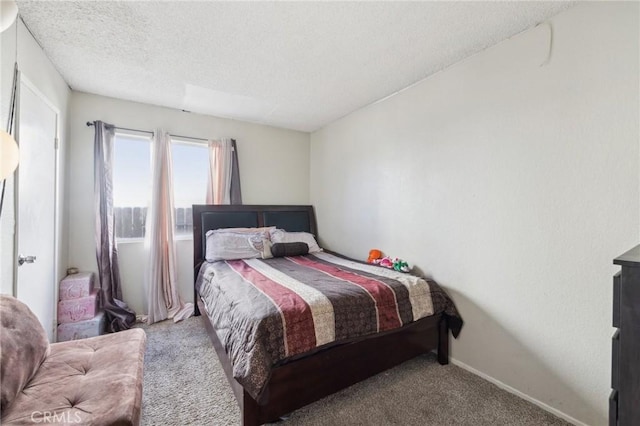 carpeted bedroom with a textured ceiling