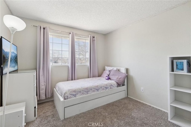 bedroom with light carpet and a textured ceiling