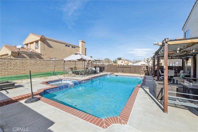 view of pool with an in ground hot tub and a patio area