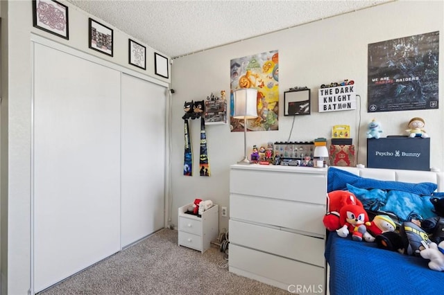 bedroom featuring light colored carpet, a closet, and a textured ceiling