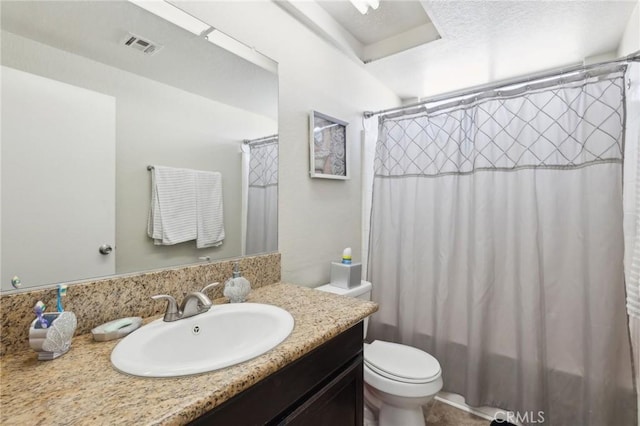 bathroom with vanity, toilet, and walk in shower